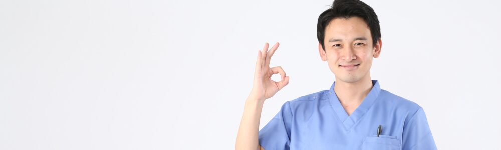 手でOKサインをする介護士